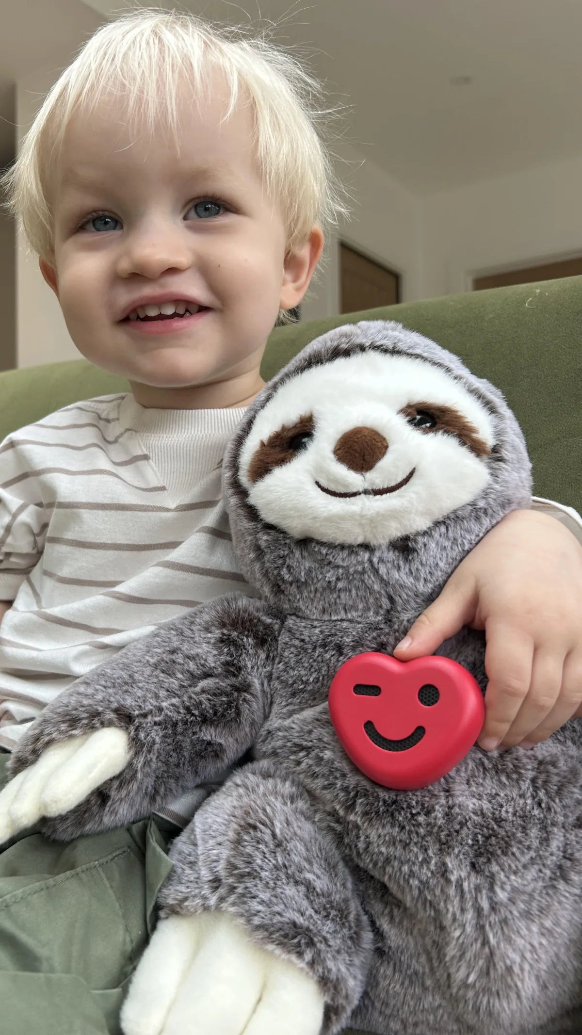 A child holding a soft toy fitted with ToyPal One
